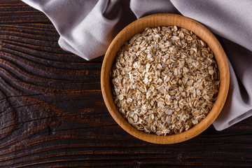 raw oatmeal on a wooden rustic background