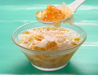 spoon taking out healthy syrup of peach gum and white fungus and lotus seeds