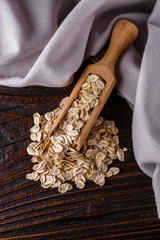 raw oatmeal on a wooden rustic background