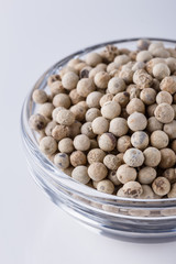 white peppers in glass bowl on white background