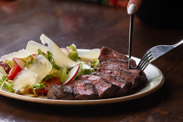 salad and sliced steak in a plate.