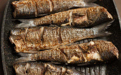 Grilled spicy fish on desk. Roasty fish concept.