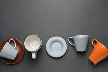 Empty cups and saucers on dark background