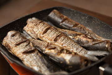 Grilled spicy fish on desk. Roasty fish concept.