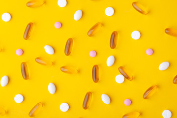 Many scattered pharmaceutical medicine vitamins, pills, fish oil softgel, tablets