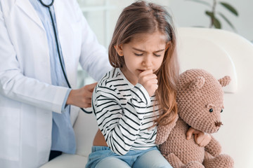 Sick little girl visiting doctor in clinic