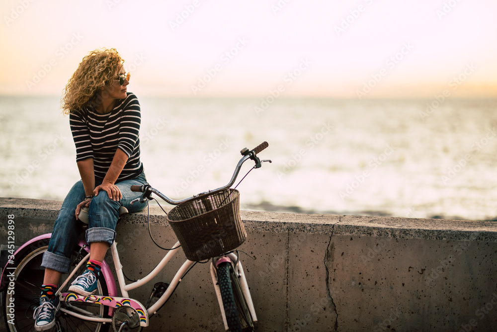 Wall mural people enjoying outdoor leisure actvity looking a beautiful coloured sunset - beautiful adult young 