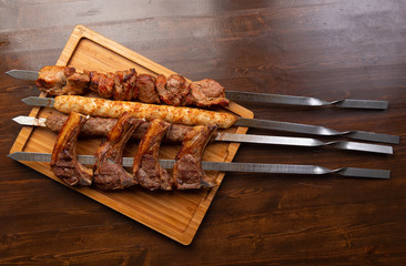 various kebabs on a wooden background