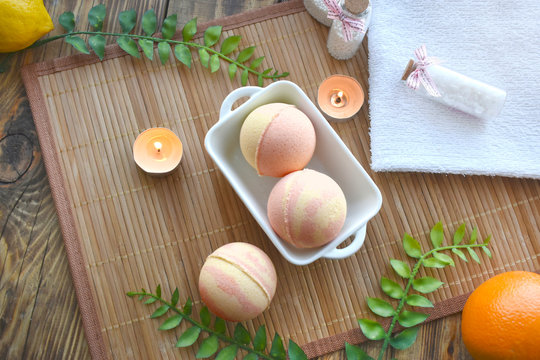 Spa Resort Setting. Still Life Flatlay With Bath Bombs, Salt And Candle On Wooden Background. Spring Or Summer Tropical Concept.