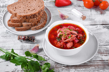 Borscht soup with meat in a white bowl. Ukrainian cuisine meal
