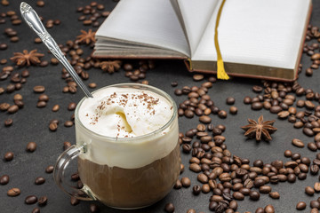 Glasse coffee, drink mix of cold coffee and ice cream. Coffee beans and notebook