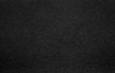 A dense industrial sheet of grey paper with a textured surface