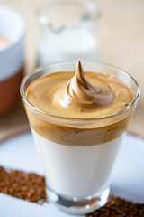 Dalgona Coffee with almond milk. Trendy corean recipe of whipped coffee, reverse latte or homemade dalgona coffee, copy space Dalgona Coffee, a combination of hot and cold beverage drink