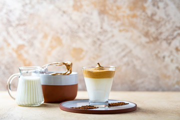 Dalgona Coffee with almond milk. Trendy corean recipe of whipped coffee, reverse latte or homemade dalgona coffee, copy space Dalgona Coffee, a combination of hot and cold beverage drink