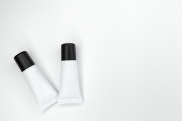 Tubes with cosmetics on a white background.