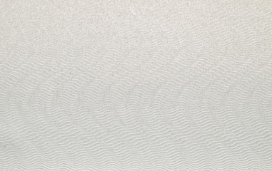 A dense industrial sheet of grey paper with a textured surface