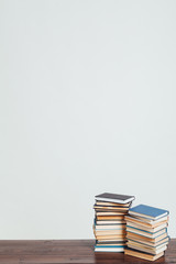a lot of stacks of educational books for college exams in the library on a white background