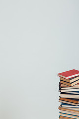 a lot of stacks of educational books for college exams in the library on a white background