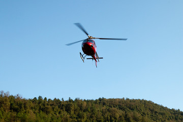 Fototapeta na wymiar A helicopter flying in the air