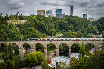 Railway bridge with a view of the city of Luxembourg on a cloudy day.
