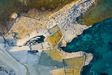 Aerial top view of nature salt pans and sea. Coastline, Malta. Selmun