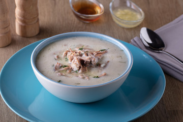 Turkish traditional tripe soup on rustic background with wooden table