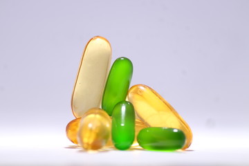 a combo of omega 3 fish oil and vitamin E capsule on white background 