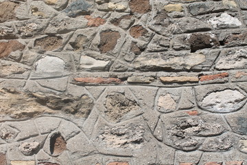 ancient stone carving in old wall made of old bricks , old walls in europe are often made of old...