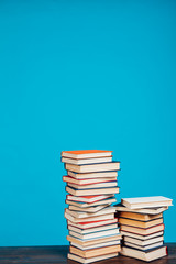 many stacks of educational books for exams at school in the library on a white background