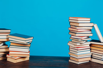 many stacks of educational books for exams at school in the library on a white background