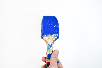 blue paintbrush in a hand