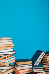 many stacks of educational books for exams at school in the library on a white background