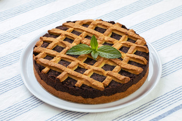 Poppy Seed Cake. Round, homemade poppy cake on a table with tablecloth.