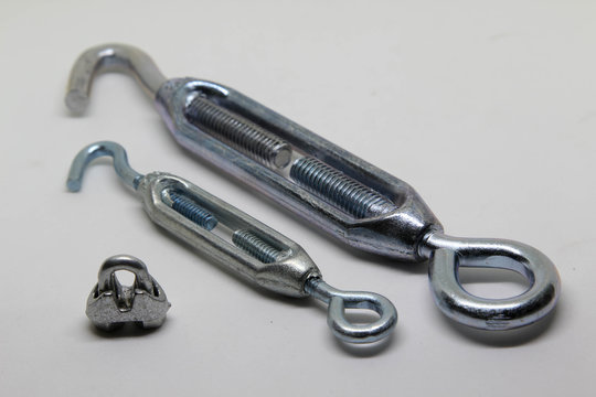 Steel turnbuckle and cable fasteners (wire rope clips) isolated on white background.