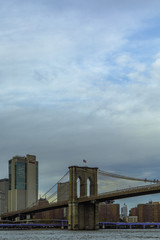 Vertical view evening shot of Brooklyn Bridge from Brooklyn Bridge Park in New York City with negative space for text.