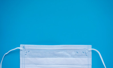 Medical disposable mask on a blue background