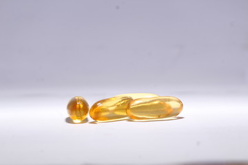 omega 3 capsule fish oil with white background in golden color 