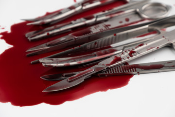Surgical instrument tools with blood, scalpel with blade, forceps tweezers, scissors for surgeon in surgery