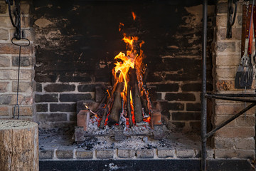 Fireplace with a burning fire, comfort and atmosphere.