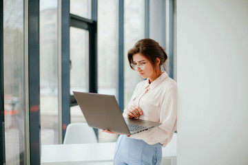 portrait of young businesswoman working on laptop in the office. 