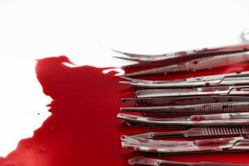 Surgical instrument tools with blood, scalpel with blade, forceps tweezers, scissors for surgeon in surgery