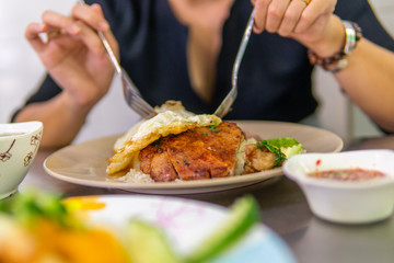 Fototapeta na wymiar Vietnamese broken rice with grilled pork chop, fried egg and meatloaf