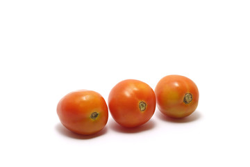 Three tomatoes (Solanum lycopersicum) isolated on white background