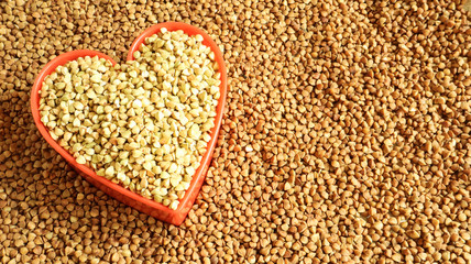 Heart shaped dry green and fried buckwheat. Great food. healthy groats. Organic raw non-fried vegetarian food. The concept of a healthy, balanced and dietary diet. Copy space