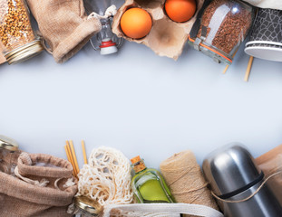 Zero waste, plastic free and sustainable lifestyle concept. Recyclable, reusable eco friendly bags, package, bottles, cans and storage containers, mesh bag. Grey background, copy space, top view