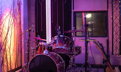 Naklejka na ściany i meble Bright recording Studio. A room for musicians ' rehearsals, with a drum kit in the background. The concept of musical creativity.