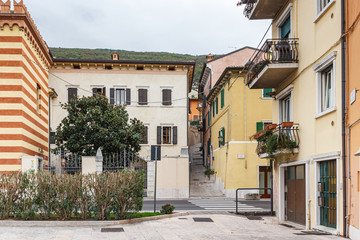 Fototapeta na wymiar Old buildings on the shores of Lake Garda in Lazise town, in Veneto, northern Italy