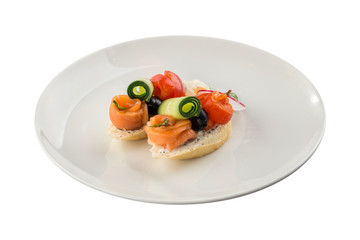 Small sandwich with salmon, tomato and cucumber on wooden board isolated on white background