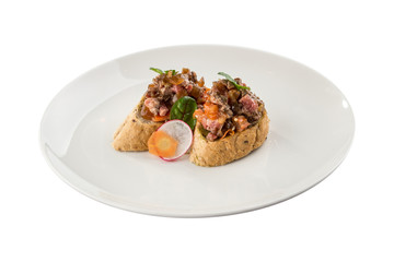 chopped roast beef with onion on bread toast bruschetta on white plate isolated on white background
