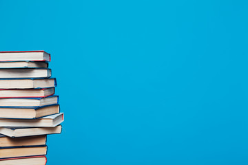 many stacks of educational books for exams at school in the library on a white background